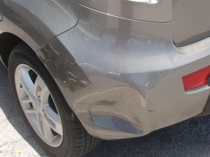Dent in left rear bumper