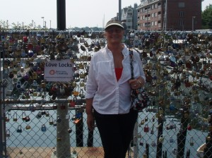 Charlene standing in front of fence with locks on it