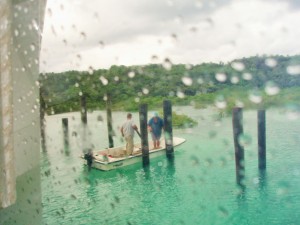 Men in Boat working in Rain
