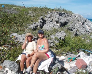 Jackie and Charlene sitting on a rock on the North Cliff Walk trail