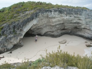 Charlene looks tiny standing at the Cave on the beach