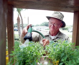 Blake Whisenant, inventor of EarthBox, watering herbs