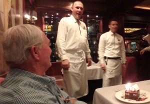 Rick; cake with candles; waiters singing