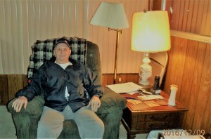 Dad sitting in chair at cabin