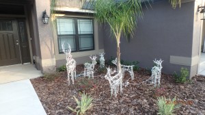 5 white metal deer in front garden