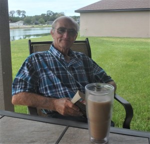 Rick sitting on back porch with morning coffee