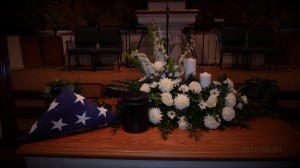 Flag, urn and flowers on the church altar