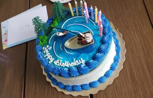 Birthday cake with man fishing in a lake in the forest