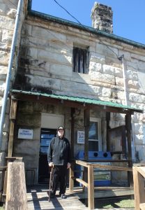 Dad standing in front of old stone jail built in 1800s