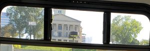 Capitol building on hill taken through bus window