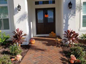 Front porch decorated for Halloween with pumpkins
