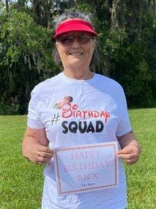 Me wearing birthday squad t-shirt and holding sign