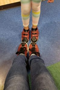 Two pairs of feet standing toe to toe
