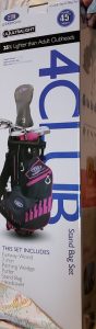 box of golf clubs in pink and black bag