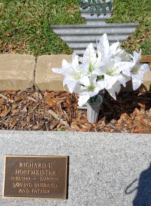 Vase of Easter lilies behind marker