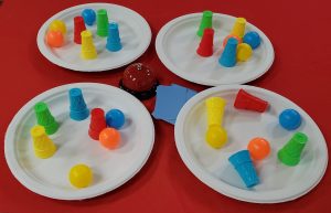 four plates with colorful plastic ice cream cones used in a game