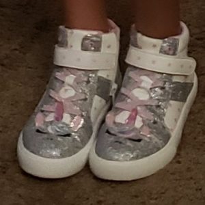 White with some pink and lots of sparkly silver high top tennis shoes