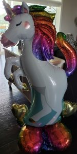 A large colorful blow-up unicorn balloon