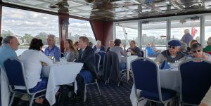 People sitting at tables for lunch on a boat