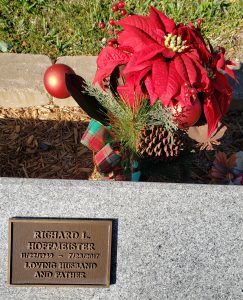 Poinsettia arrangement behind Rick's memorial stoned