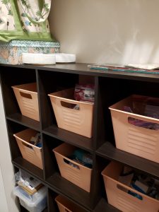 Bins filled with craft and sewing materials in the storage unit