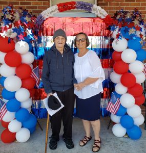 Tom Cambre with daughter Charlene Hoffmeister surrounded by red, white and blue balloons