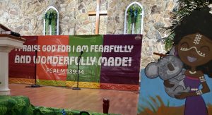 A colorful banner with a bible verse on it