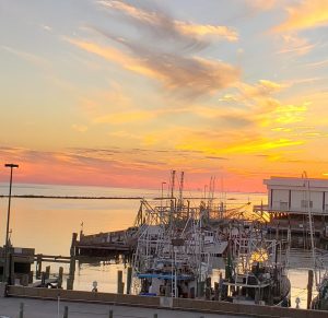 Sunset over the Gulf of Mexico with shrimp boats in the foreground