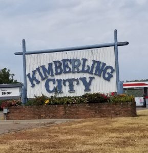 A blue and white sign that says Kimberling City