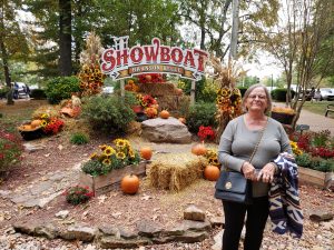 Jackie standing in front of Showboat Branson Belle Sign