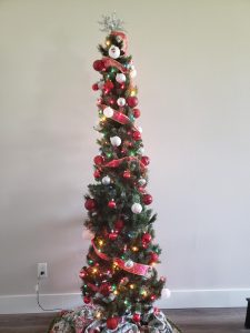 Pencil Christmas tree decorated in red, white and silver