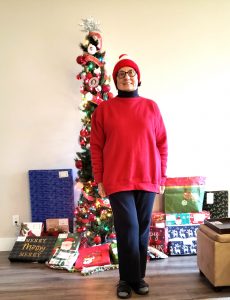 Charlene wearing warm clothes in front of tree