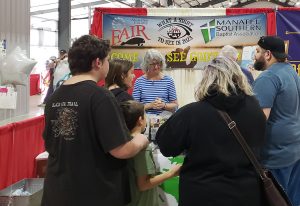 Family talking to volunteers at the County Fair