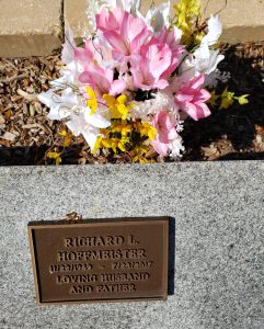 Pink, white and yellow lillies placed at Rick's marker