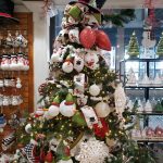 Christmas tree decorated with snowman and snowflake ornaments and a Top Hat for a topper