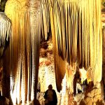 Gold and white stalactites surounding Jackie
