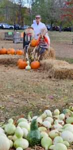 Charlene with pumpkins and green gourds