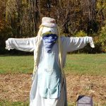 A woman scarecrow with long blond braids