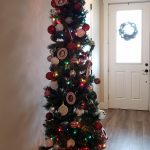 Decorated pencil tree with front door with wreath in the background