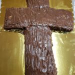 Cross-shaped cake with chocolate frosting