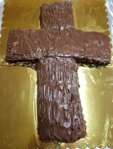 Cross-shaped cake with chocolate frosting