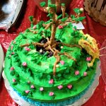 3-tiered cake frosted green with tree of life on top